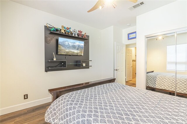 bedroom with a closet, hardwood / wood-style floors, and ceiling fan