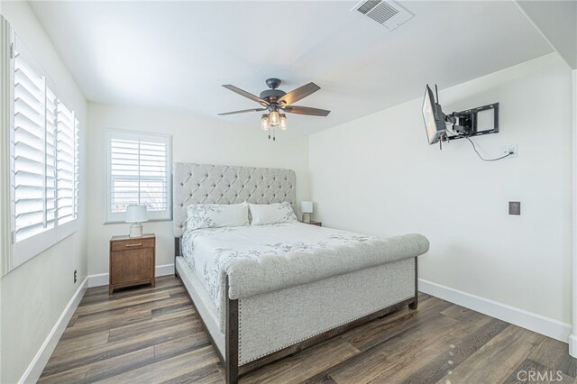 bedroom with ceiling fan and dark wood-type flooring