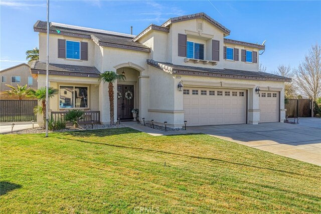 view of front of house with a front yard and a garage