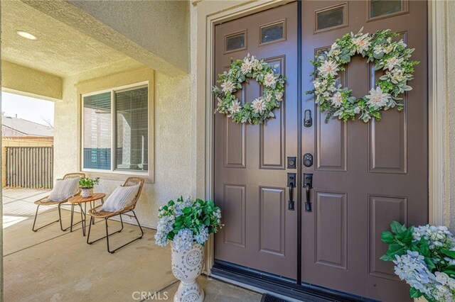 doorway to property featuring covered porch