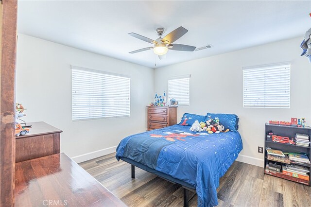 bedroom with ceiling fan and wood-type flooring