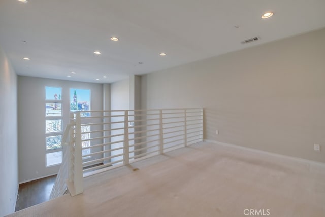 carpeted empty room featuring plenty of natural light