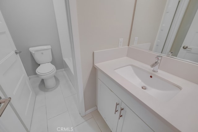 bathroom featuring toilet, vanity, and tile patterned flooring