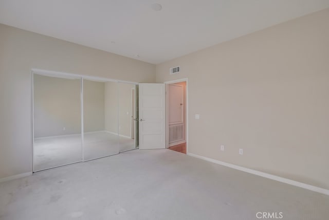 unfurnished bedroom featuring a closet and carpet floors