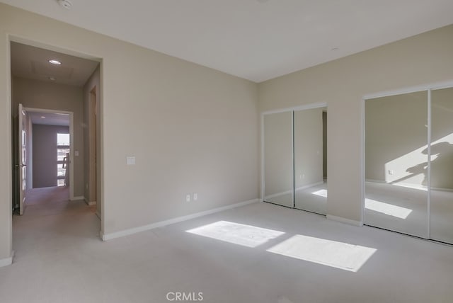 unfurnished bedroom with light colored carpet