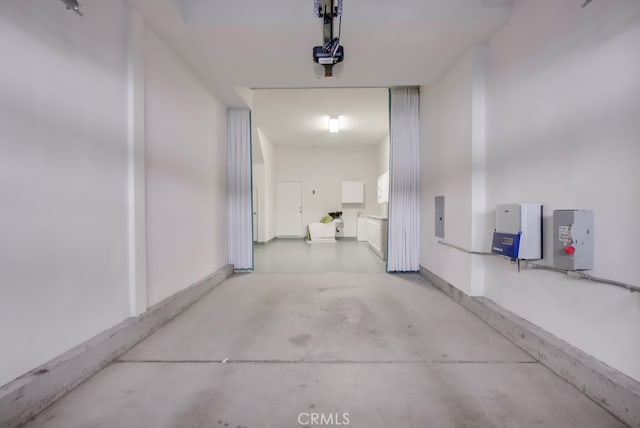 corridor featuring concrete flooring and electric panel