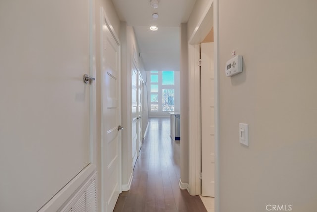 hall with dark wood-type flooring