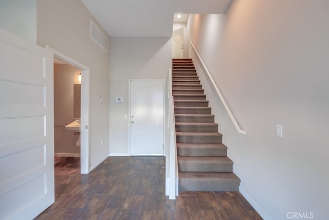 stairway with hardwood / wood-style floors