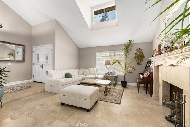 living room with a fireplace and high vaulted ceiling