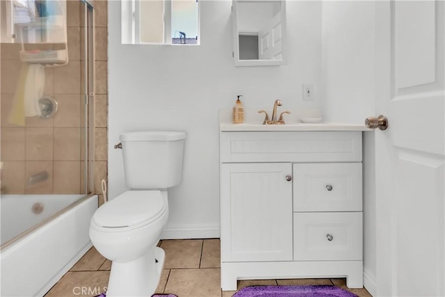 full bathroom featuring toilet, vanity, tile patterned floors, and shower / bath combination with glass door