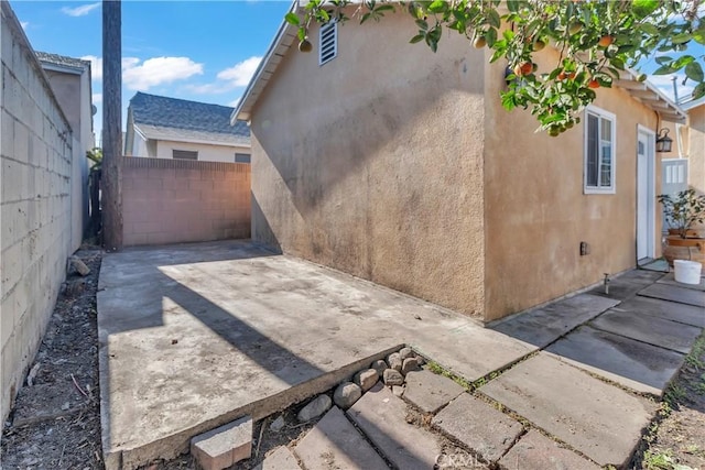 view of side of property featuring a patio area