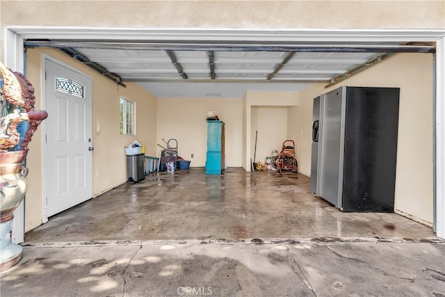 garage with stainless steel fridge with ice dispenser