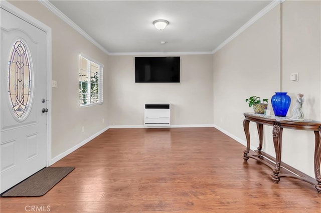 entryway with hardwood / wood-style floors and crown molding