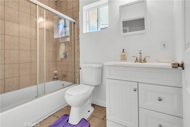 full bathroom with toilet, enclosed tub / shower combo, vanity, and tile patterned floors