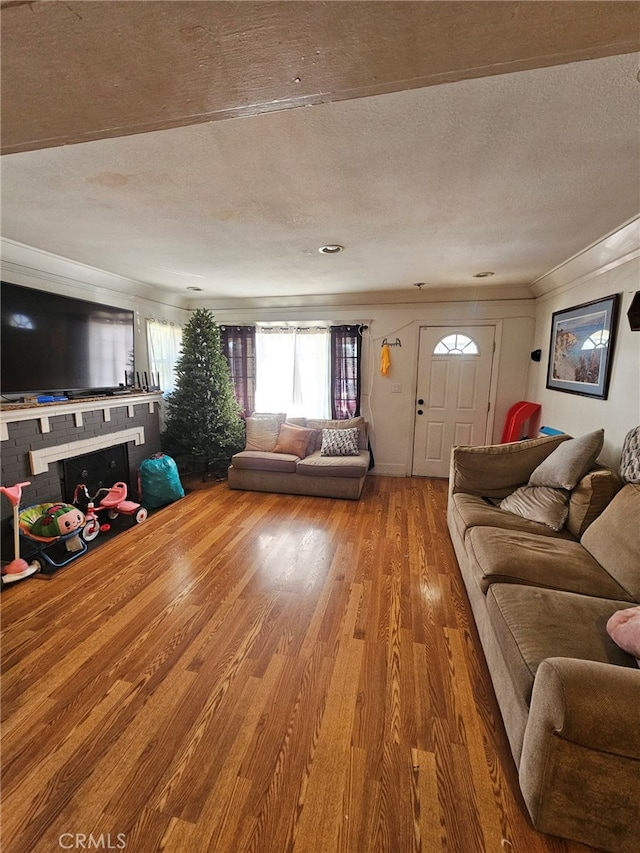 living room featuring wood-type flooring and a textured ceiling