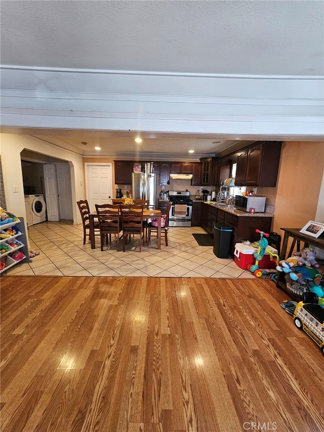 tiled dining area featuring washer / clothes dryer