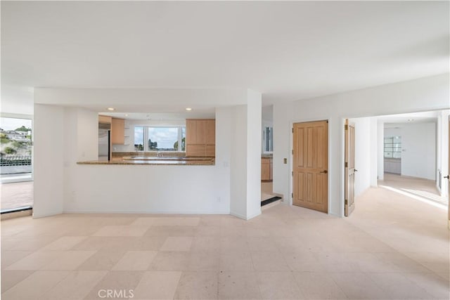 unfurnished living room with recessed lighting