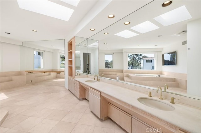 full bathroom featuring double vanity, tile patterned floors, a sink, and recessed lighting