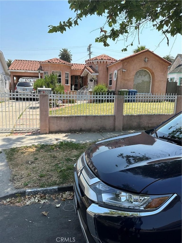 mediterranean / spanish-style house featuring a front yard