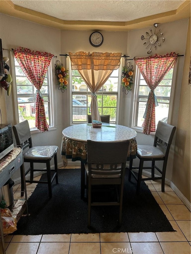 dining room with light tile patterned floors and a textured ceiling