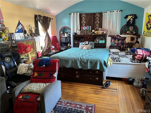 bedroom with hardwood / wood-style floors and vaulted ceiling