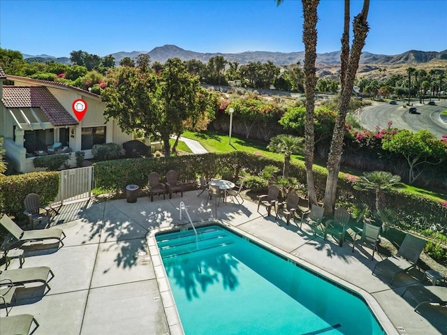 view of pool featuring a mountain view and a patio