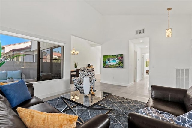 living room with an inviting chandelier, concrete flooring, and lofted ceiling