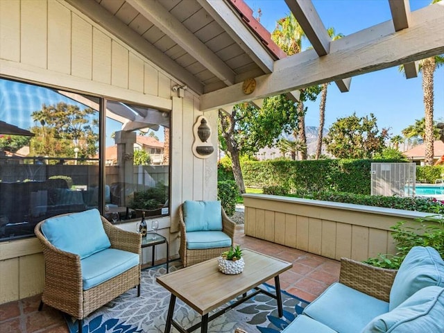 sunroom featuring lofted ceiling with skylight