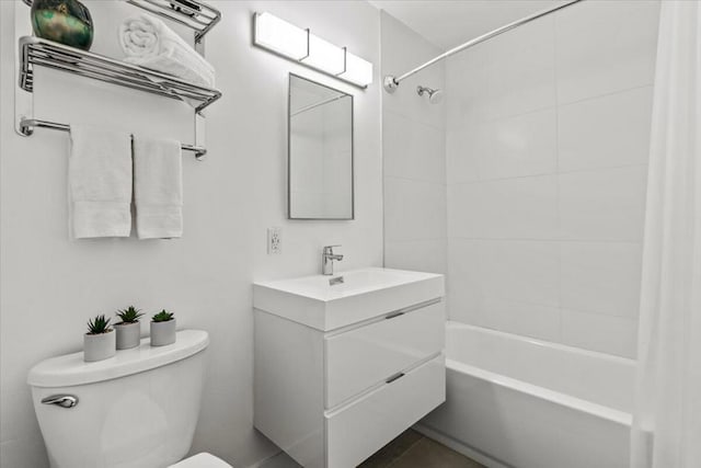 full bathroom featuring toilet, tiled shower / bath combo, and vanity