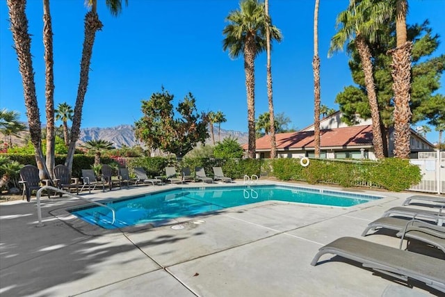 view of swimming pool featuring a mountain view and a patio area