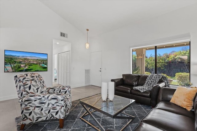 living room with high vaulted ceiling