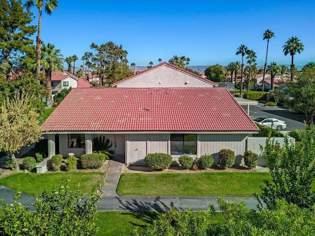 mediterranean / spanish-style house with a front lawn