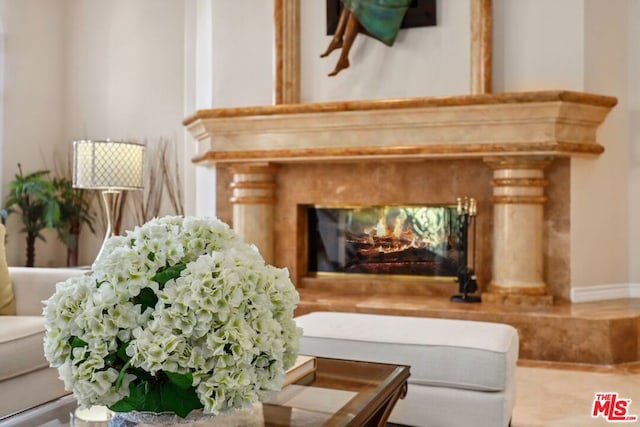 sitting room with a high end fireplace