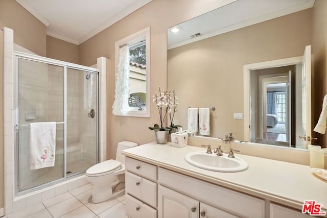 bathroom with ornamental molding, a healthy amount of sunlight, tile patterned floors, and vanity