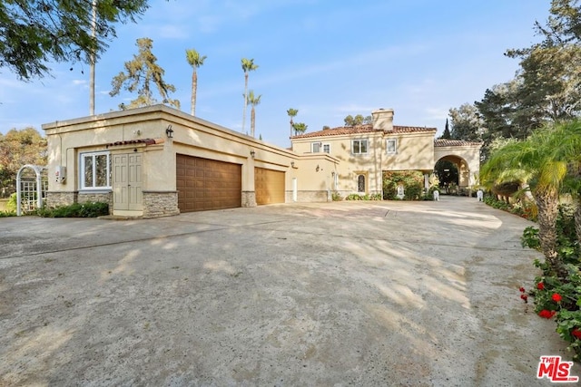 mediterranean / spanish house with a garage