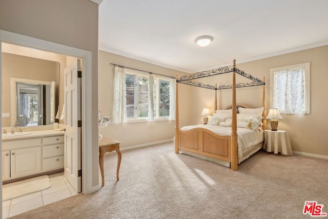 bedroom with light carpet, ensuite bath, and multiple windows