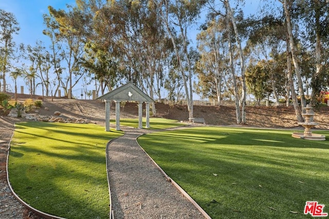 surrounding community with a gazebo and a lawn