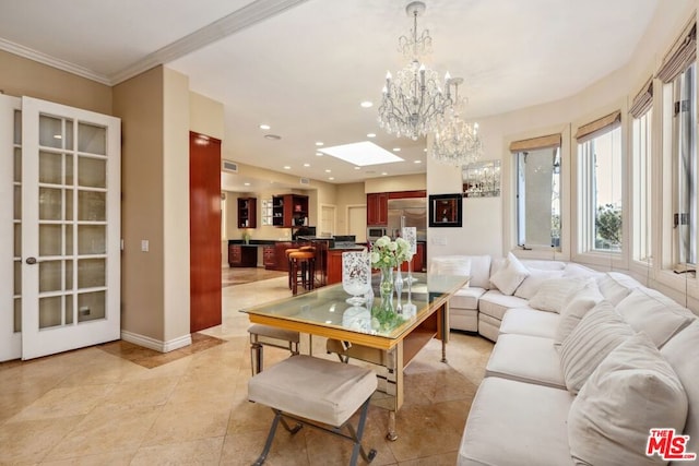 tiled living room featuring a skylight, ornamental molding, and a notable chandelier