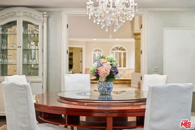 dining area featuring an inviting chandelier and ornamental molding