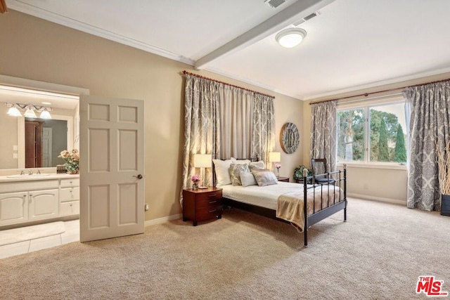 carpeted bedroom featuring ornamental molding, sink, and ensuite bath