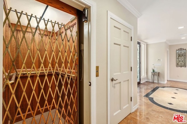 interior space with ornamental molding and elevator