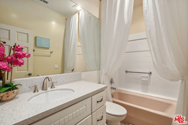 full bathroom featuring toilet, shower / bath combo, and vanity