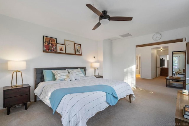 bedroom featuring ceiling fan and light carpet