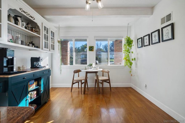 sitting room with light wood-type flooring and beam ceiling