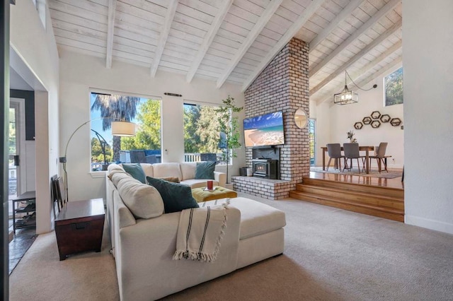 carpeted living room with wood ceiling, a wood stove, high vaulted ceiling, beam ceiling, and an inviting chandelier