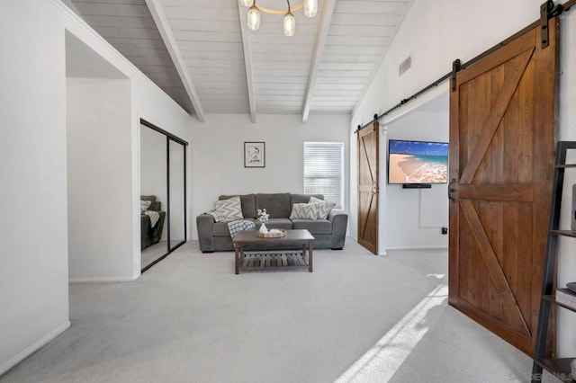 living room featuring lofted ceiling with beams, light carpet, and a barn door