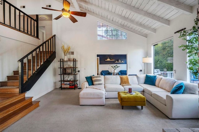 living room featuring a healthy amount of sunlight, high vaulted ceiling, ceiling fan, and carpet flooring