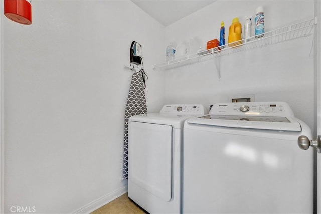 washroom featuring separate washer and dryer and light tile patterned flooring