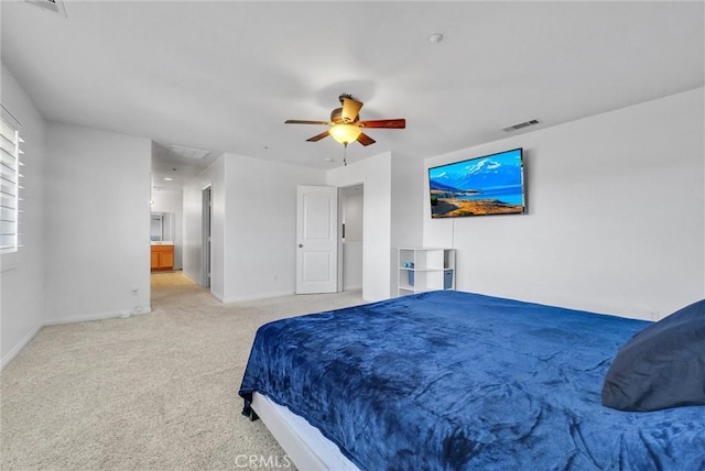 bedroom with ceiling fan, connected bathroom, and light carpet