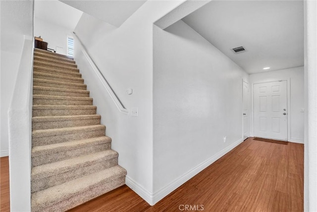 stairway with hardwood / wood-style floors